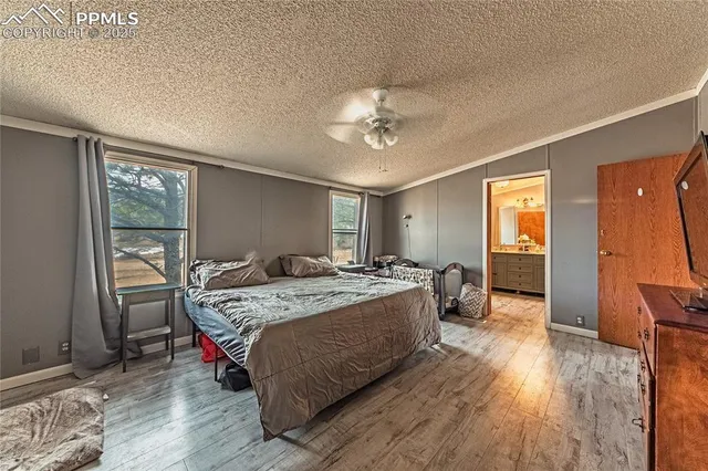 a spacious bedroom with a bed and a table in it