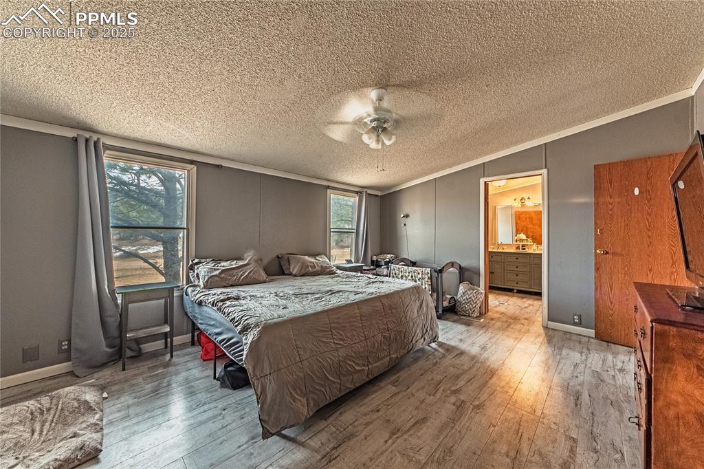 36 Valley Circle Guffey, CO 80820 - Photo 12 of 40 a spacious bedroom with a bed and a table in it