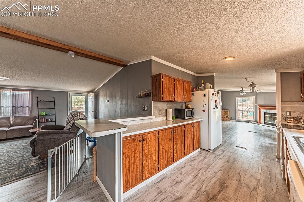 36 Valley Circle Guffey, CO 80820 - Photo 19 of 40 a open kitchen with cabinets a sink and a wooden floor