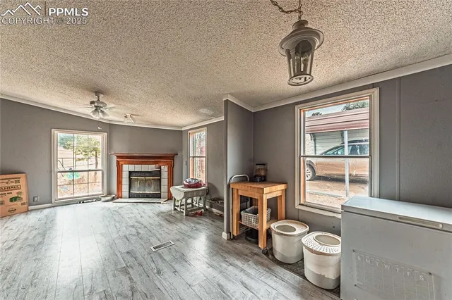 a living room with furniture a fireplace and a flat screen tv