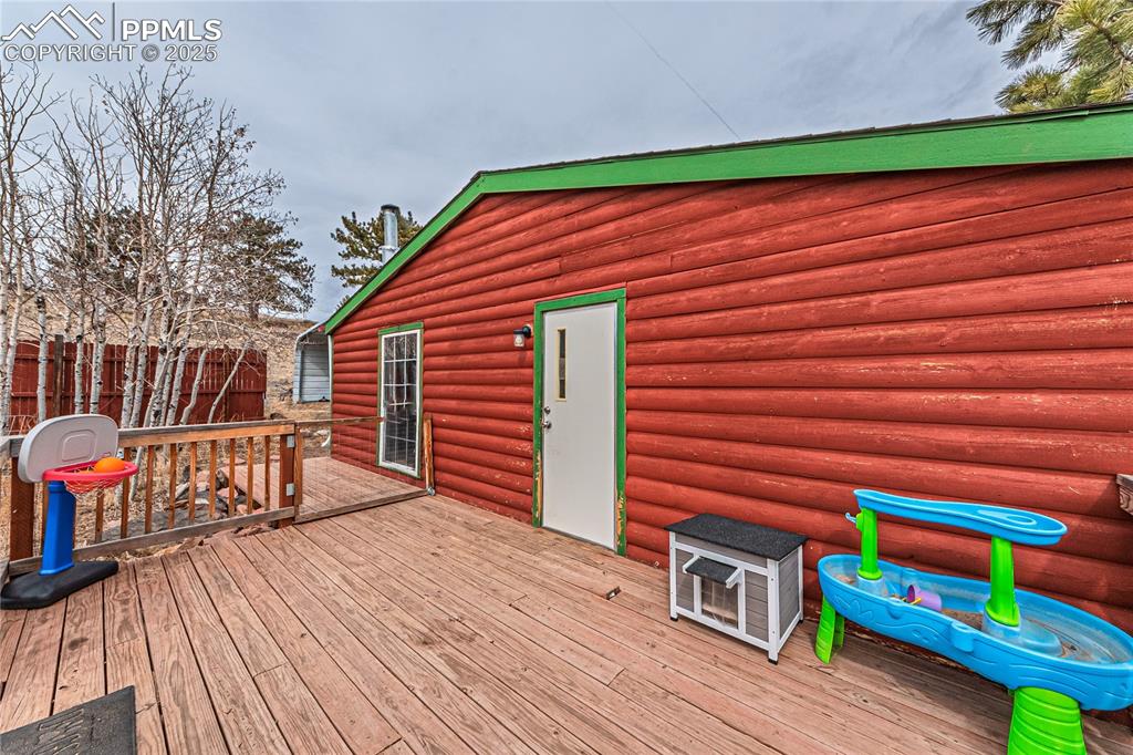 36 Valley Circle Guffey, CO 80820 - Photo 27 of 40 a backyard of a house with wooden floor yard and furniture