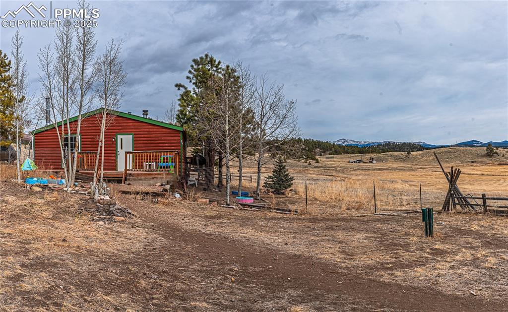 36 Valley Circle Guffey, CO 80820 - Photo 6 of 40 a view of a lake with a bench and trees in the background