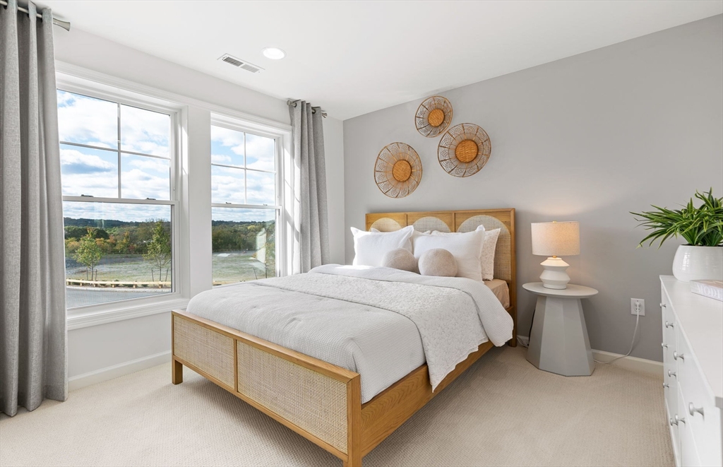 2 Mason Way, Unit 6524 Woburn, MA 01801 - Photo 25 of 31 a spacious bedroom with a bed and a window