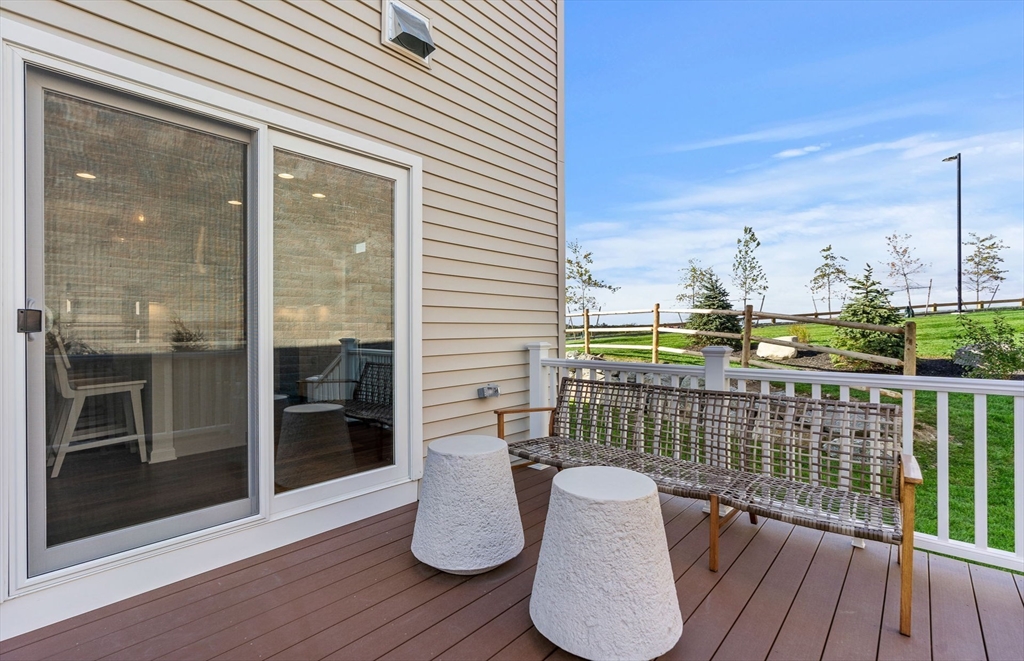 2 Mason Way, Unit 6524 Woburn, MA 01801 - Photo 28 of 31 a balcony with table and chairs