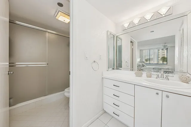 a spacious bathroom with a granite countertop sink mirror and double