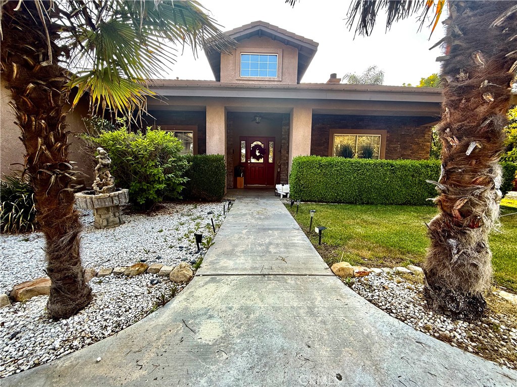 9869 Kehl Canyon Road Cherry Valley, CA 92223 - Photo 19 of 27 a view of house with a yard and potted plants