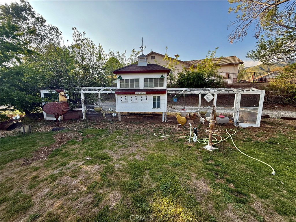 9869 Kehl Canyon Road Cherry Valley, CA 92223 - Photo 20 of 27 an aerial view of a house with table and chairs under an umbrella