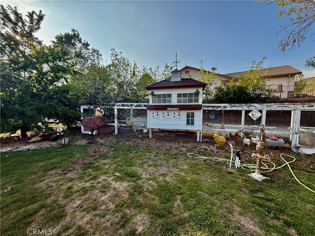 9869 Kehl Canyon Road Cherry Valley, CA 92223 - Photo 24 of 27 a view of a house with a yard