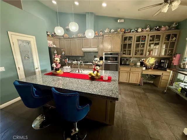 a room with granite countertop lots of wooden furniture