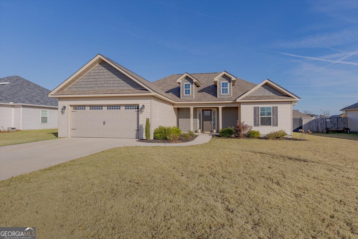 104 Gunner Lane Perry, GA 31069 - Photo 1 of 48 a front view of a house with a garden