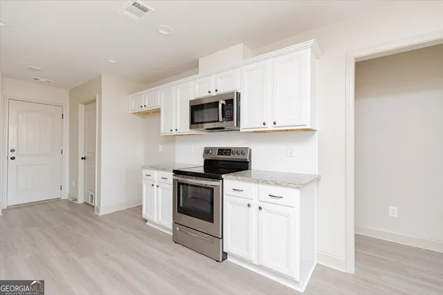 a kitchen with a stove and a microwave