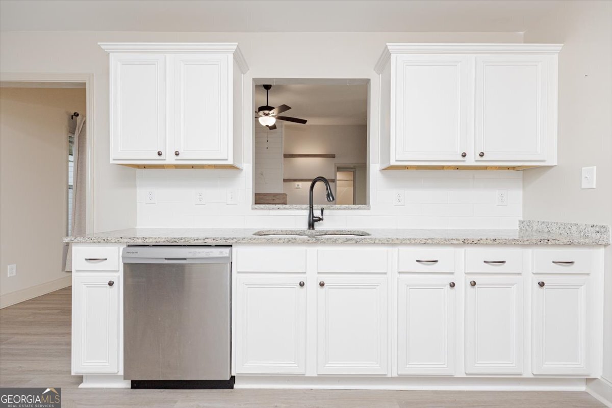 104 Gunner Lane Perry, GA 31069 - Photo 21 of 48 a kitchen with granite countertop a sink cabinets and stainless steel appliances