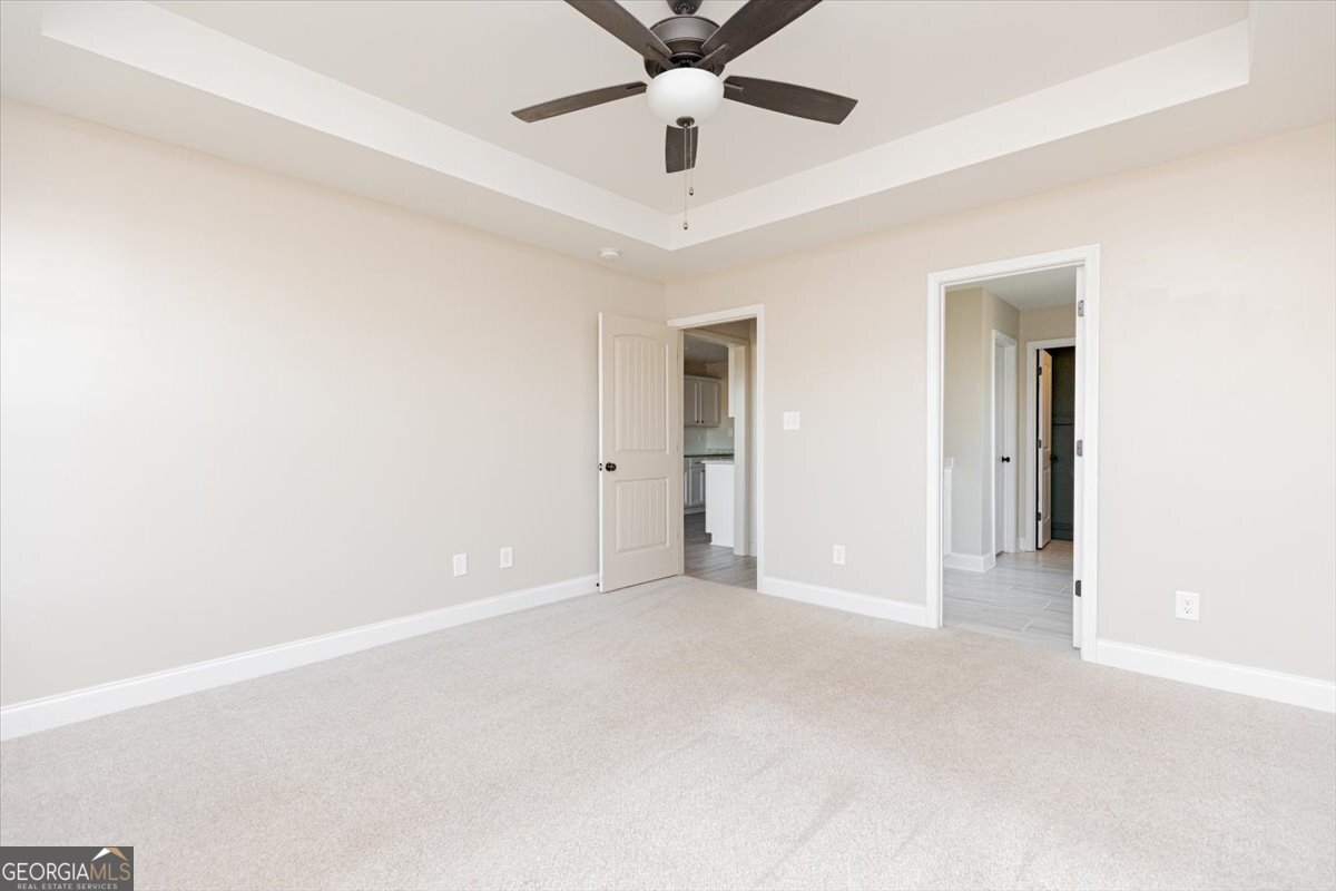 104 Gunner Lane Perry, GA 31069 - Photo 27 of 48 an empty room with chandelier fan and windows