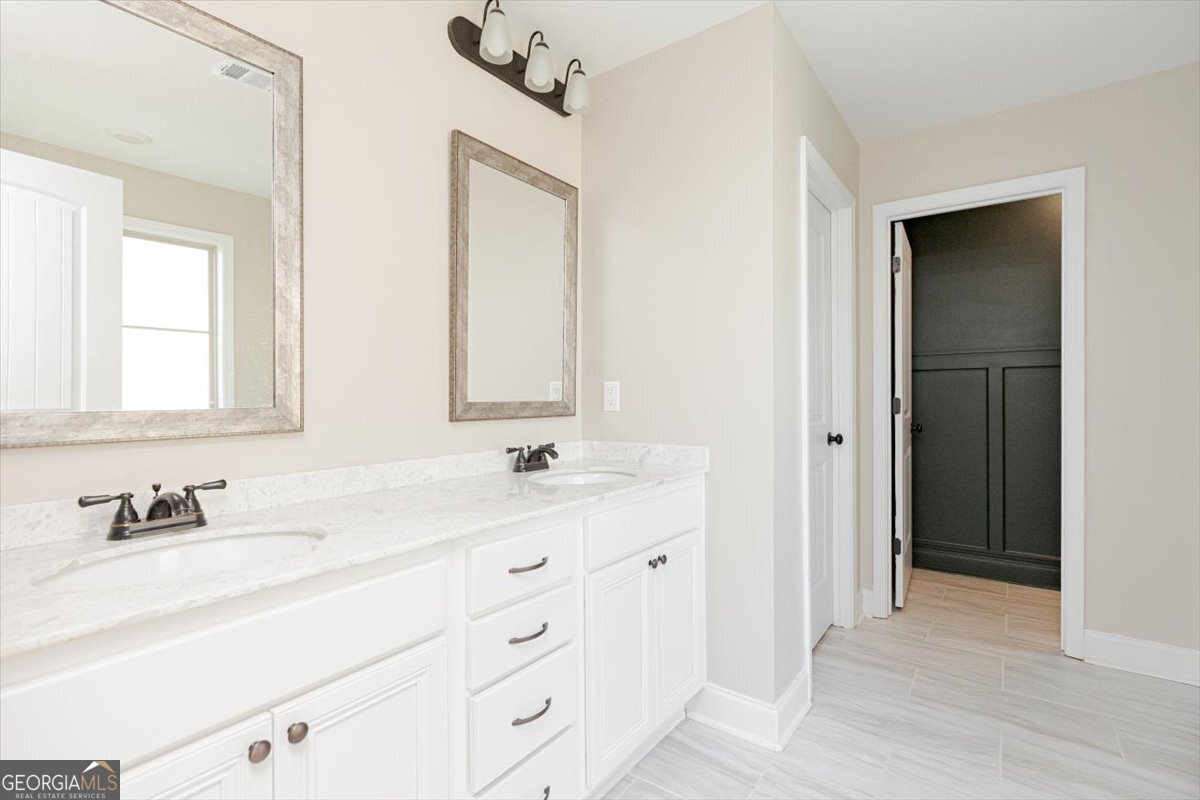 104 Gunner Lane Perry, GA 31069 - Photo 28 of 48 a bathroom with a double vanity sink and mirror