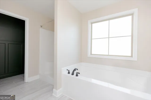 a white bath tub sitting next to a window