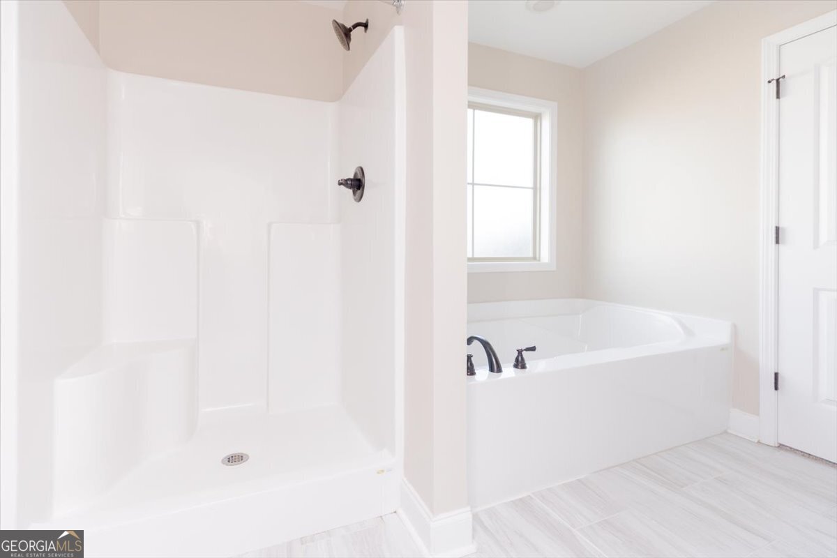 104 Gunner Lane Perry, GA 31069 - Photo 30 of 48 a white bath tub sitting next to a window