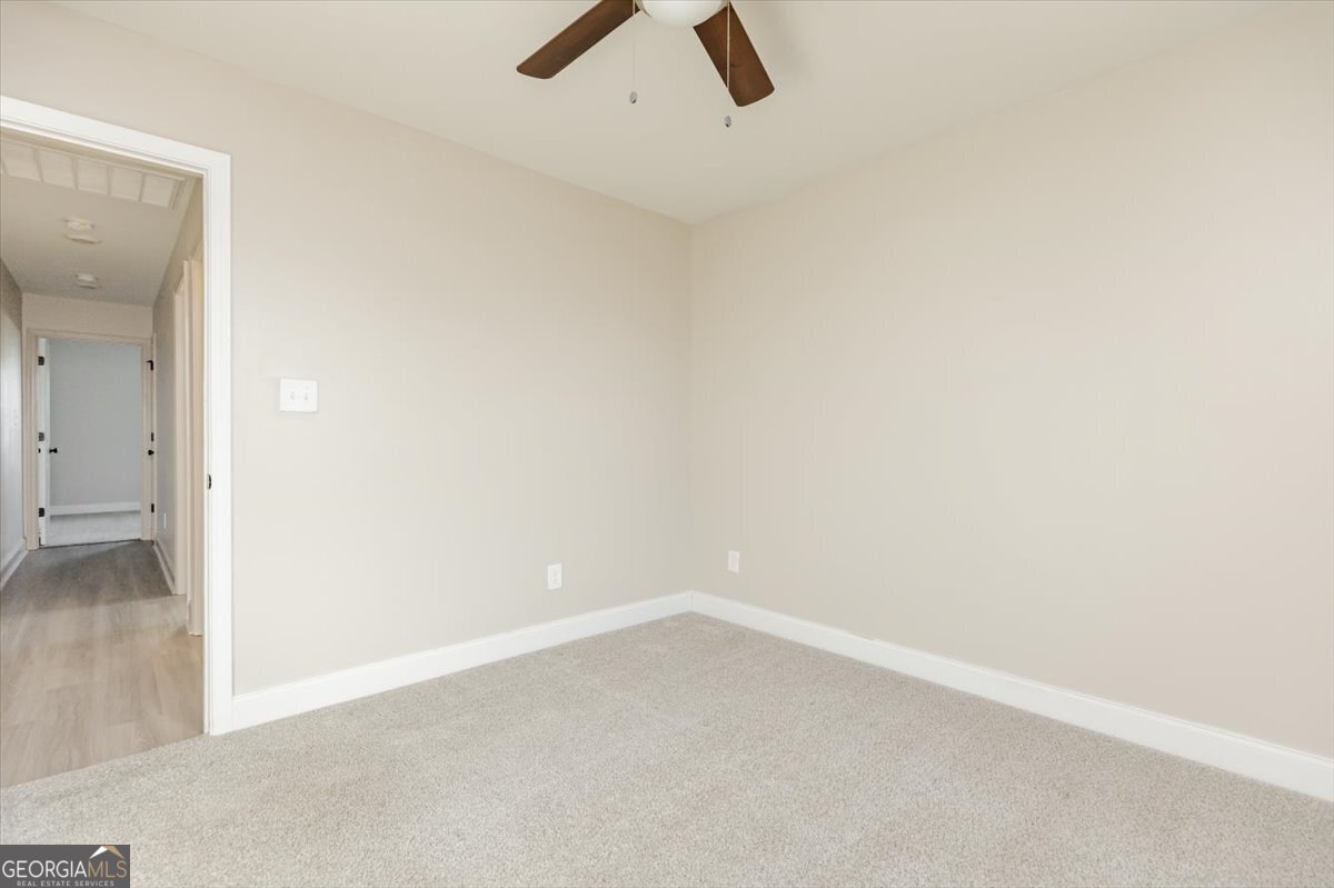 104 Gunner Lane Perry, GA 31069 - Photo 33 of 48 an empty room with a ceiling fan and window
