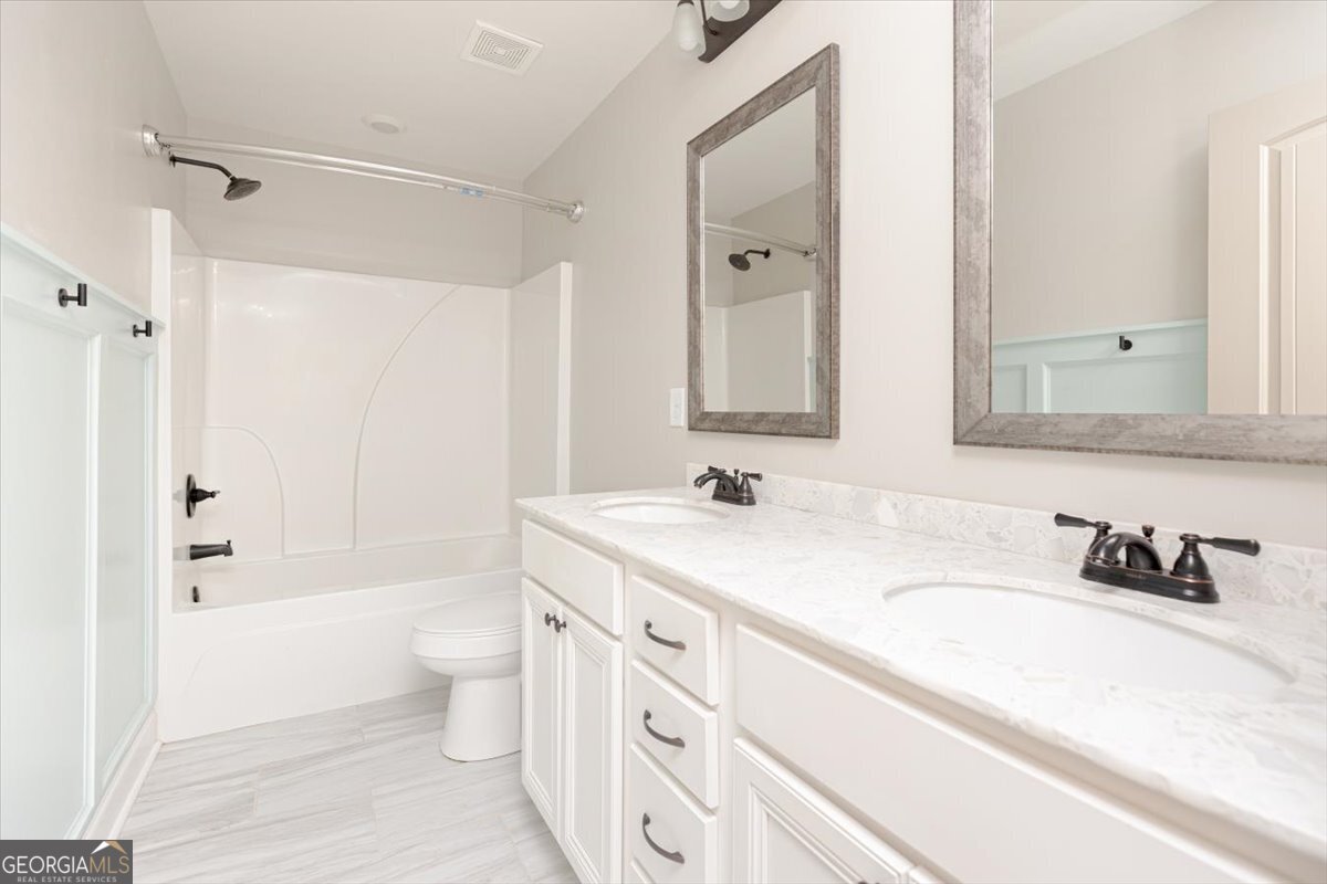 104 Gunner Lane Perry, GA 31069 - Photo 34 of 48 a bathroom with a sink a toilet a shower and a mirror