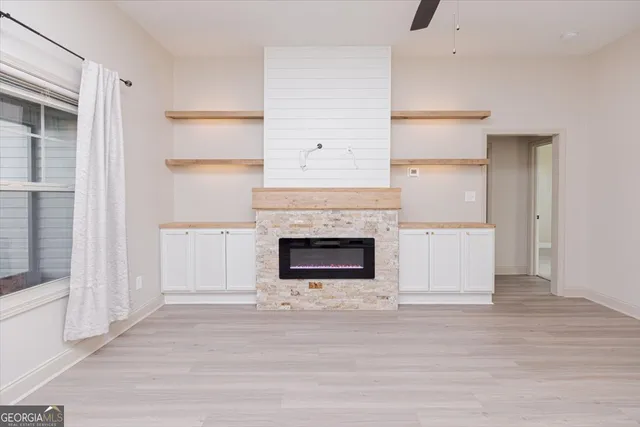a living room with a fireplace and a rug