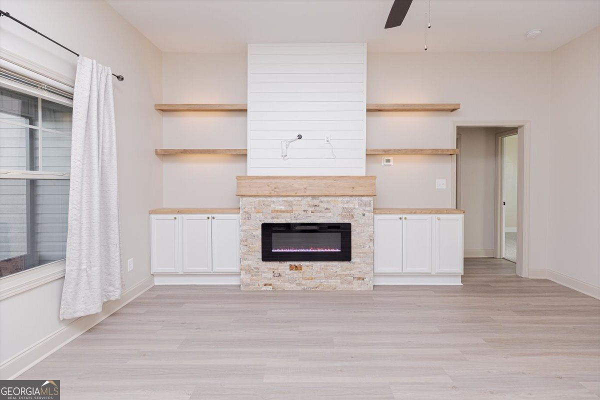 104 Gunner Lane Perry, GA 31069 - Photo 8 of 48 a living room with a fireplace and a rug
