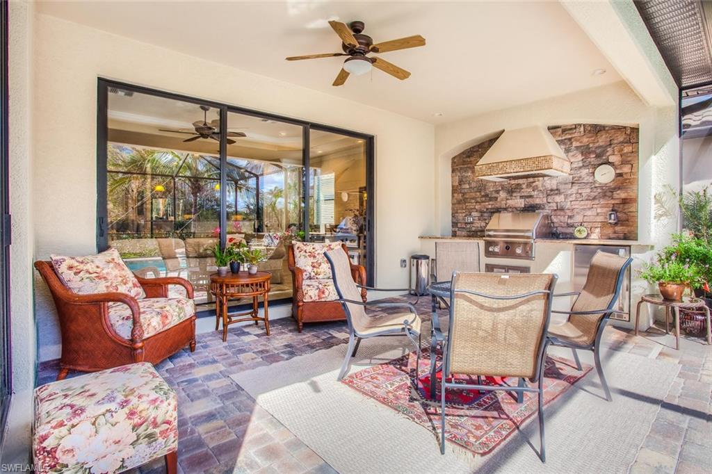 9526 Piacere Way Naples, FL 34113 - Photo 21 of 25 a dining room with furniture and a floor to ceiling window
