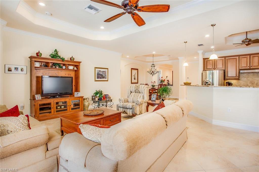 9526 Piacere Way Naples, FL 34113 - Photo 5 of 25 a living room with furniture and a flat screen tv