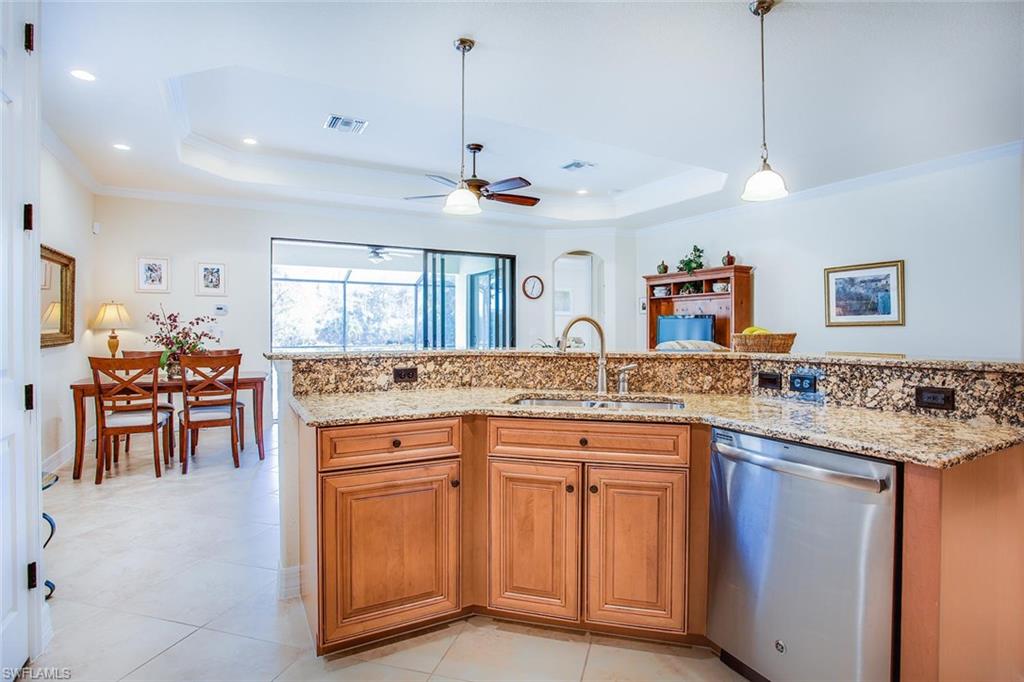 9526 Piacere Way Naples, FL 34113 - Photo 8 of 25 a open kitchen with stainless steel appliances granite countertop living room and chairs