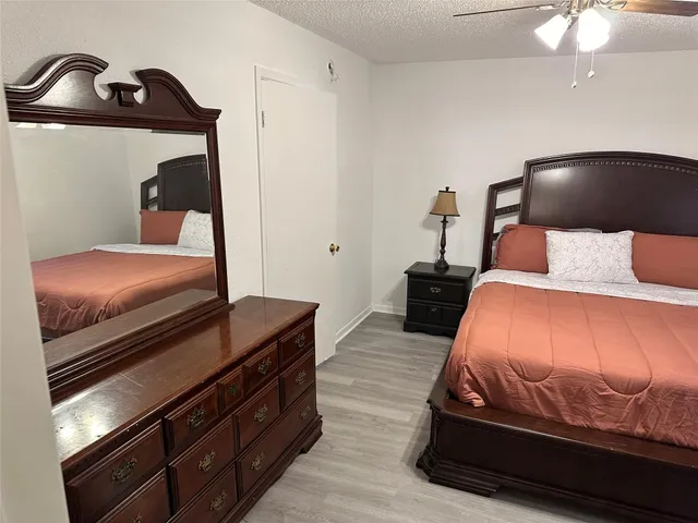 a bedroom with a bed and lamp