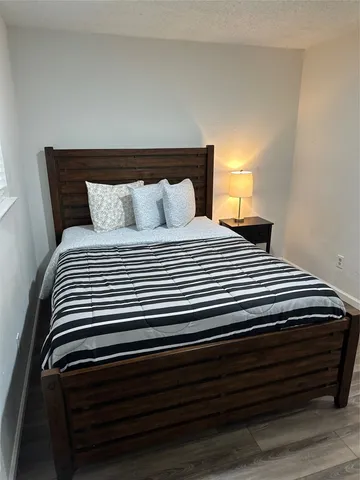 a bedroom with a bed and a night stand