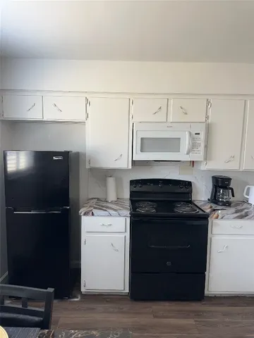 a kitchen with a stove and a refrigerator