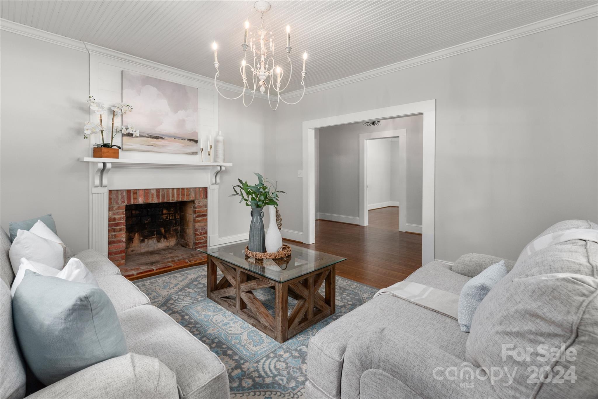 110 Park Road West Indian Trail, NC 28079 - Photo 11 of 41 a living room with furniture a chandelier and a fireplace