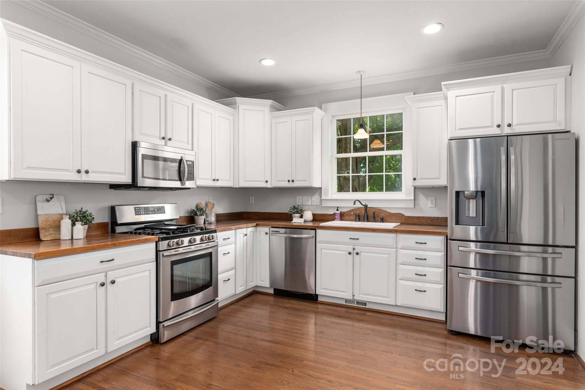 110 Park Road West Indian Trail, NC 28079 - Photo 21 of 41 a kitchen with stainless steel appliances granite countertop a refrigerator sink and cabinets
