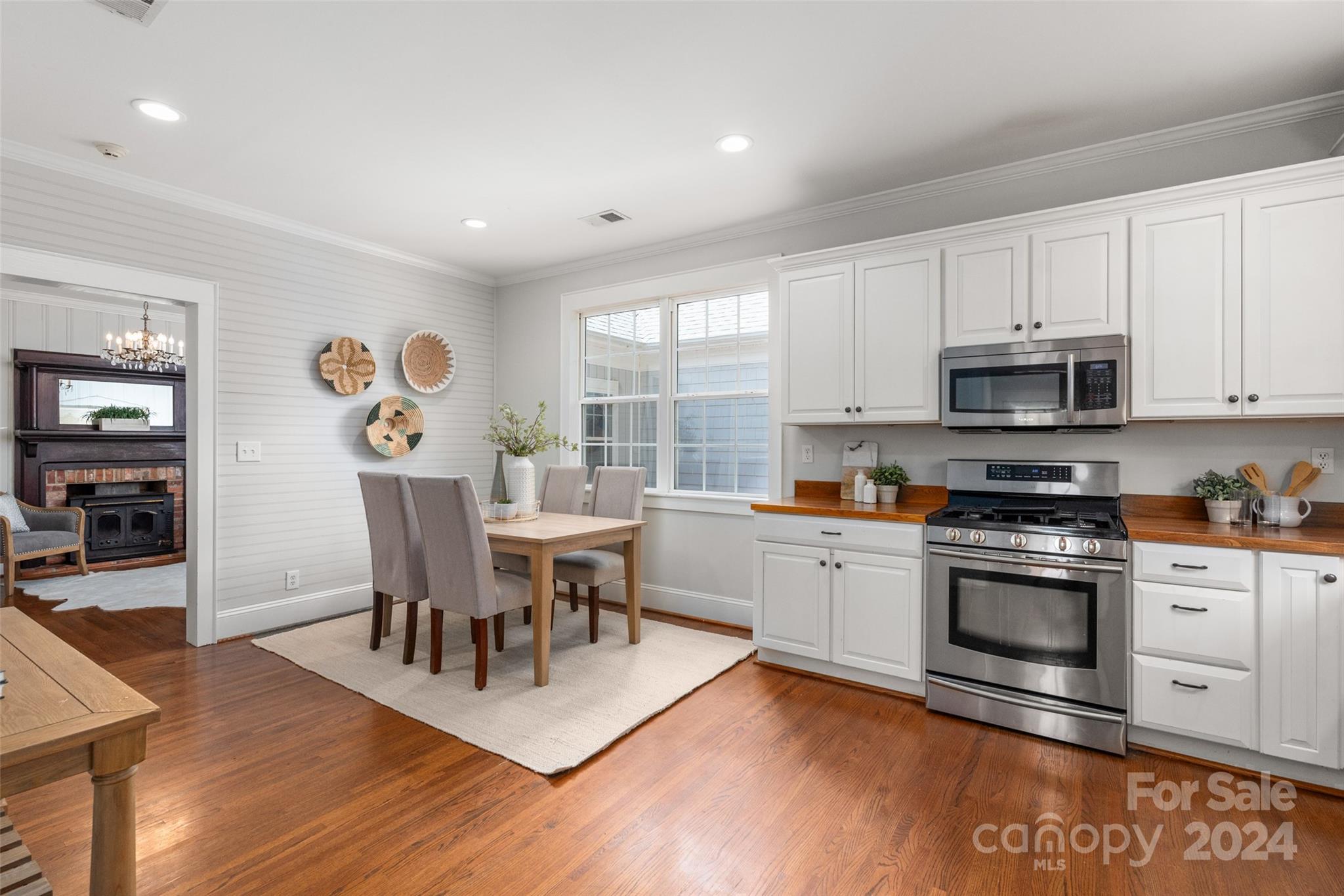 110 Park Road West Indian Trail, NC 28079 - Photo 24 of 41 a kitchen with stainless steel appliances granite countertop a stove a sink a microwave a dining table and chairs