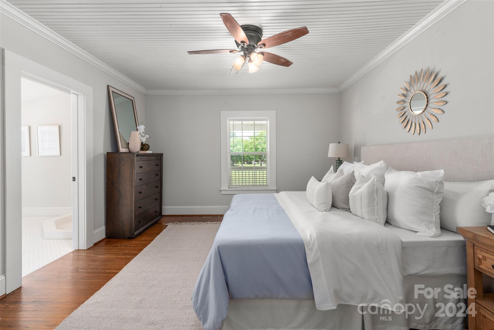 110 Park Road West Indian Trail, NC 28079 - Photo 30 of 41 a bedroom with a large bed and a chandelier