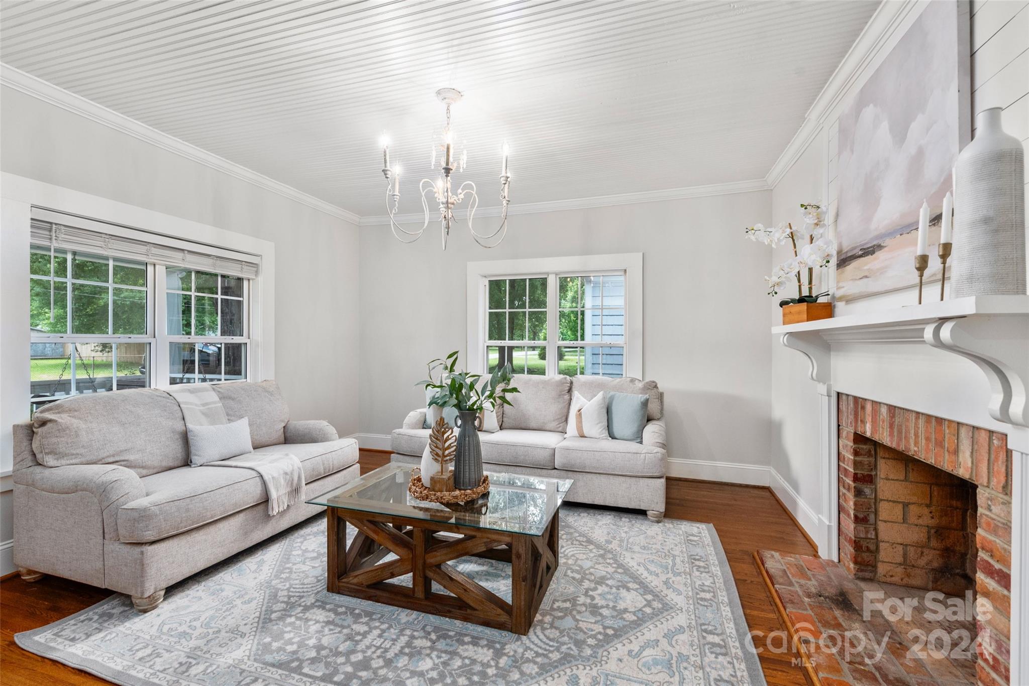 110 Park Road West Indian Trail, NC 28079 - Photo 8 of 41 a living room with furniture a fireplace and a chandelier