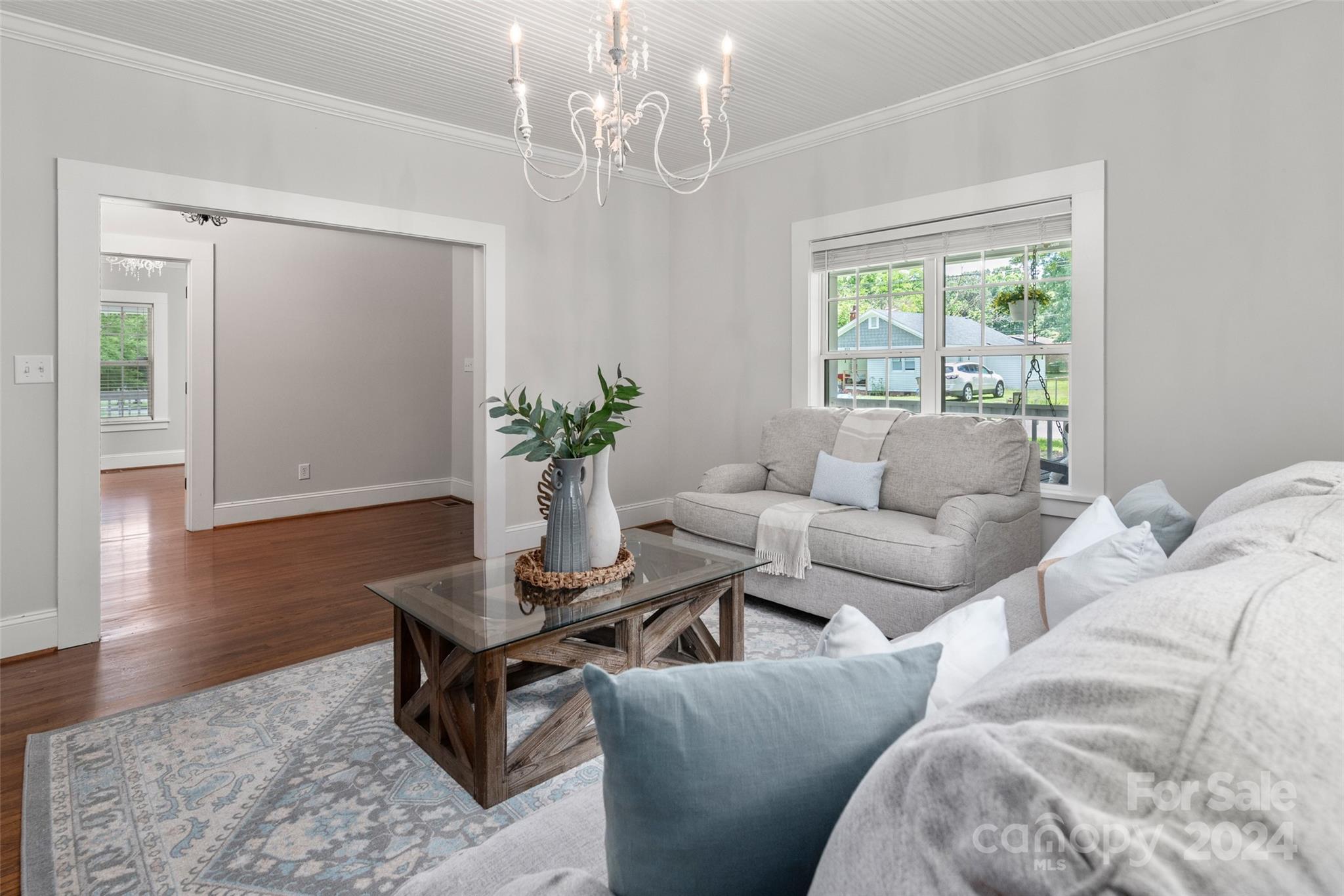 110 Park Road West Indian Trail, NC 28079 - Photo 10 of 41 a living room with furniture and a chandelier