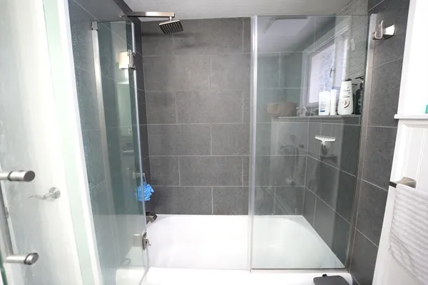 a bathroom with a shower and a tub
