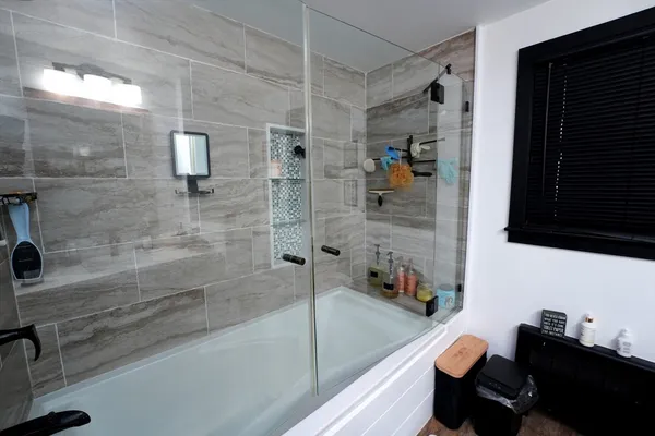 a bathroom with a bathtub and a shower