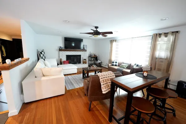 a living room with furniture a fireplace and a flat screen tv