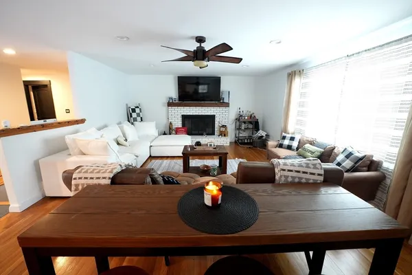 a living room with furniture kitchen view and a fireplace