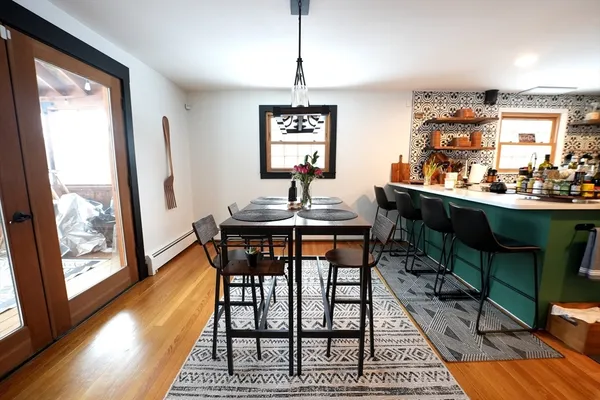 a view of a dining room with furniture window and wooden floor