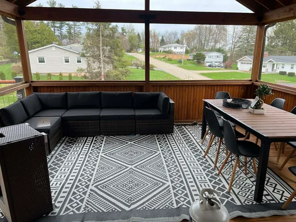 a room view with a couch and large windows