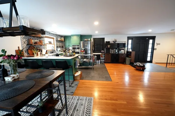 a view of a dining room with furniture window and wooden floor