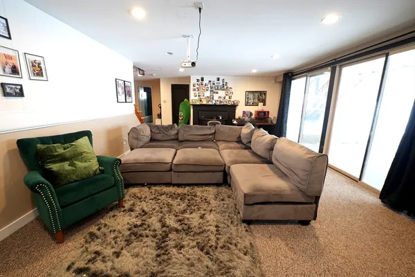 a living room with furniture and a chandelier