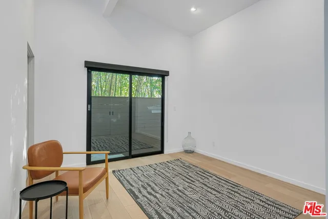 a bedroom with a bed and a chair