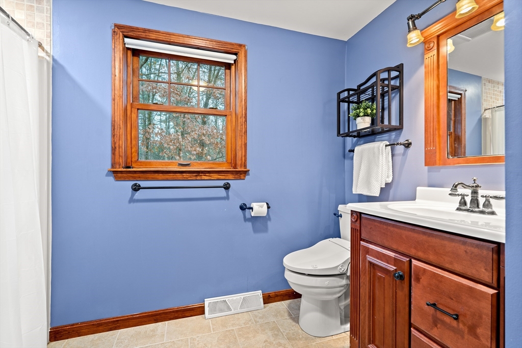 91 Century Way Dunstable, MA 01827 - Photo 18 of 31 a bathroom with a toilet a sink a vanity and mirror