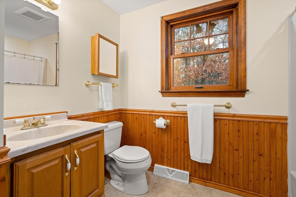 91 Century Way Dunstable, MA 01827 - Photo 21 of 31 a bathroom with a sink a mirror and a toilet