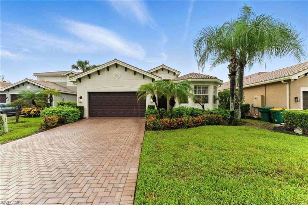 6899 Del Mar Terrace Naples, FL 34105 - Photo 1 of 41 a front view of a house with a garden and palm trees