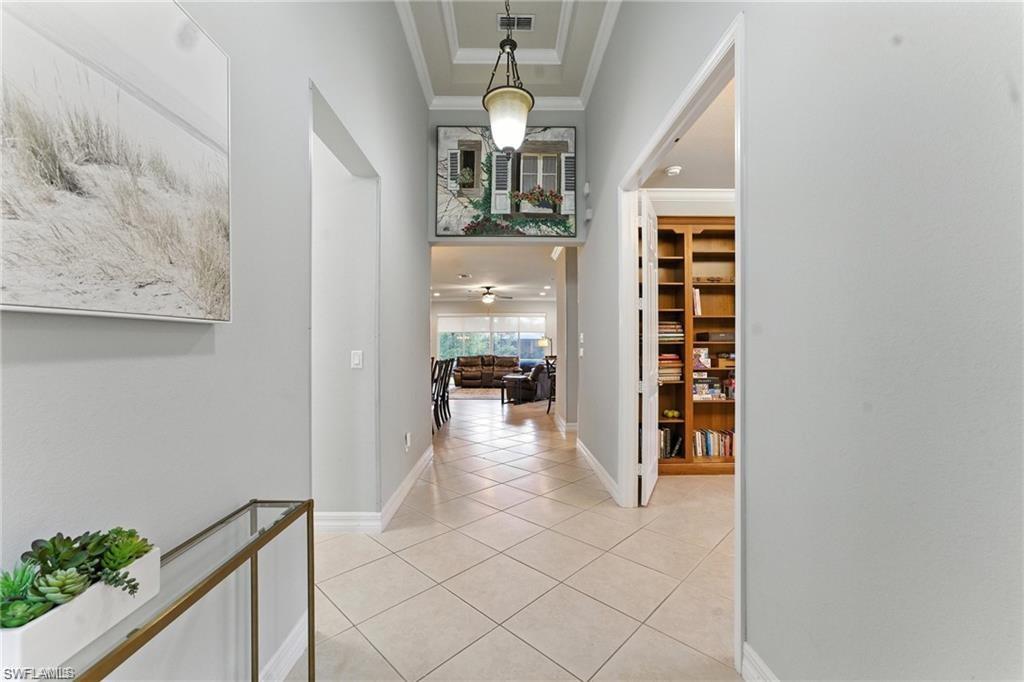 6899 Del Mar Terrace Naples, FL 34105 - Photo 13 of 41 a view of a hallway to a livingroom with furniture
