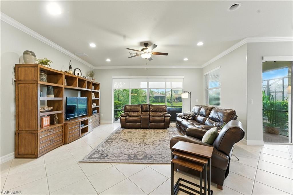 6899 Del Mar Terrace Naples, FL 34105 - Photo 41 of 41 a living room with furniture and a flat screen tv